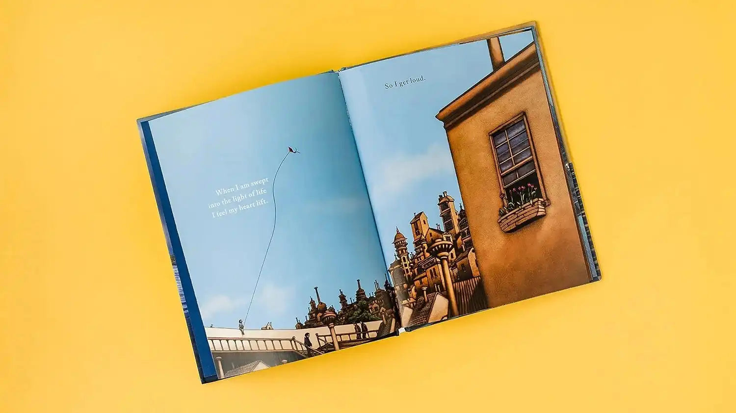 Open book with a scenic image of a building on a yellow background