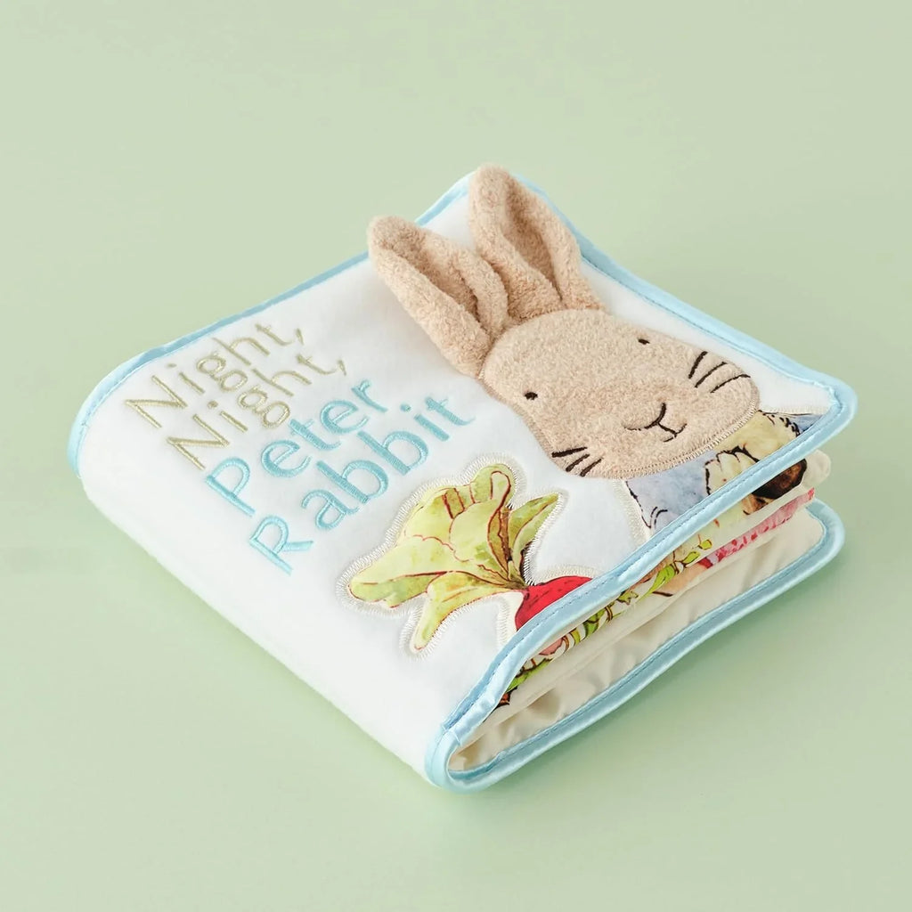 Children's book titled 'Goodnight Peter Rabbit' with a soft toy on a light green background