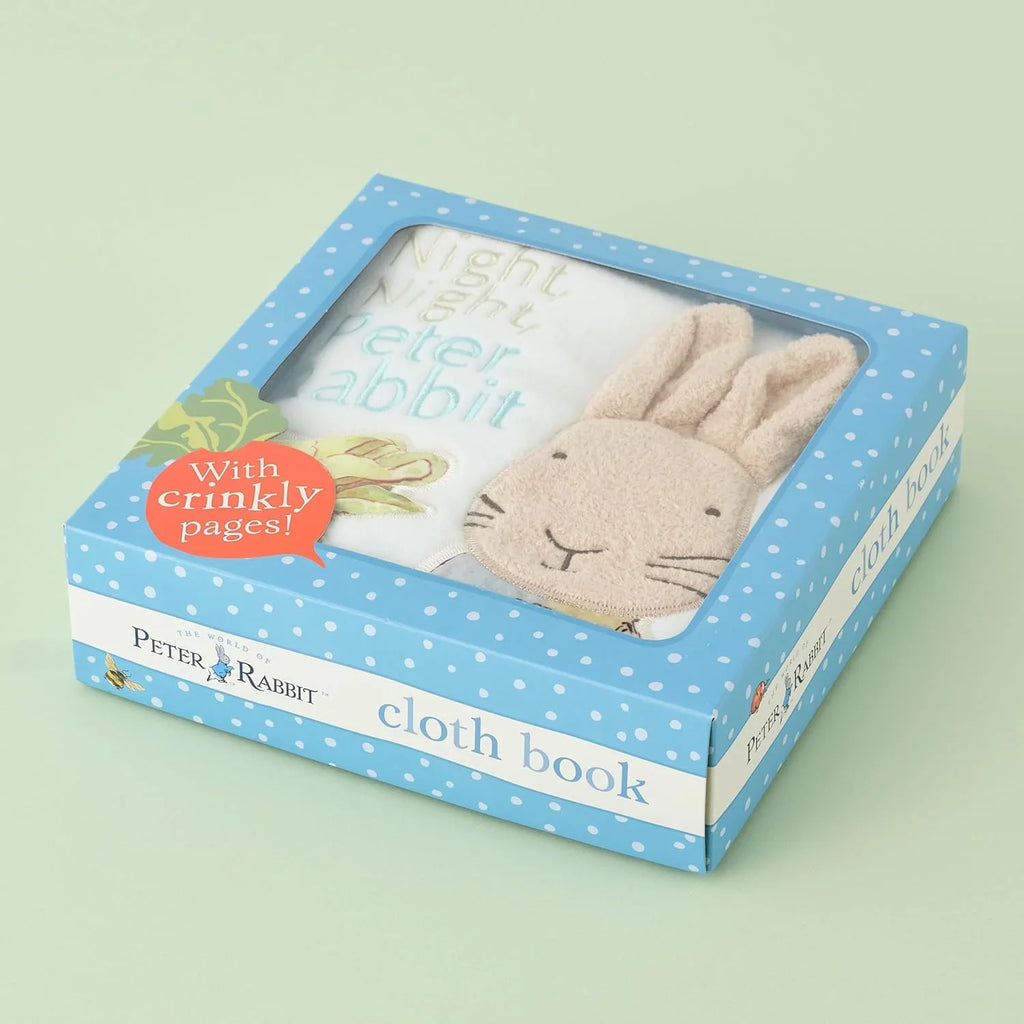 Peter Rabbit cloth book packaging with blue polka dot design on a light green background