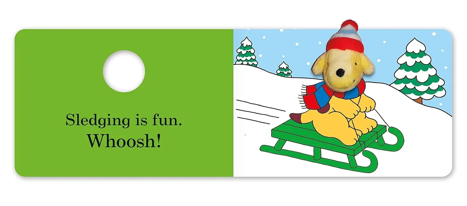 Children's book page with a cartoon dog on a sled and text about sledding.