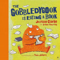 Book cover of 'The Gobbledygook is Eating a Book' with an orange creature eating books.