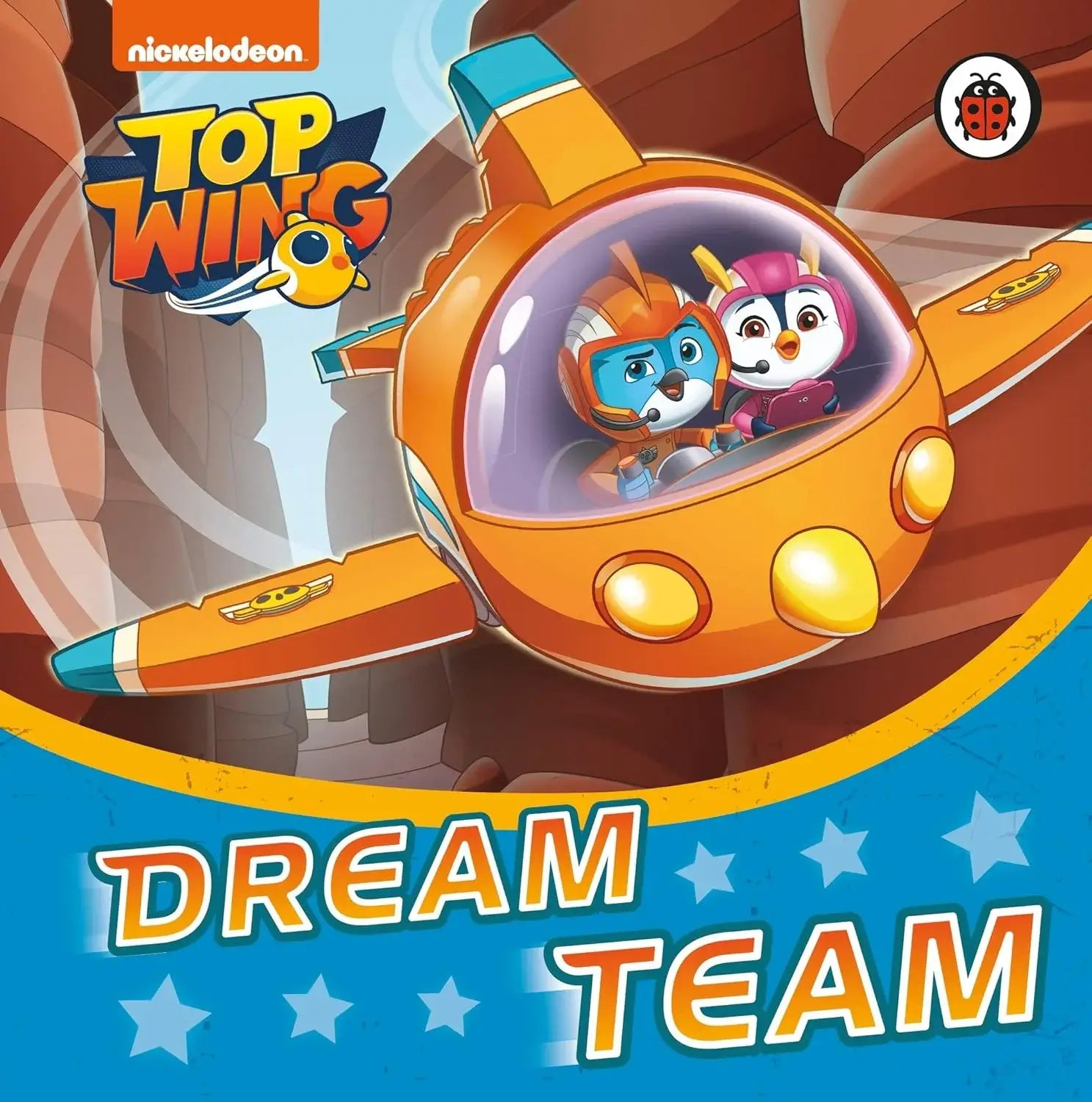 Book cover of 'Top Wing: Dream Team' featuring two animated characters in an orange airplane.
